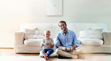 Vater und Sohn Videospiele vor weißer Couch mit sauberem und unabhängigen Strom aus der sonnenCommunity